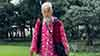 An elderly Chinese man wearing brightly coloured clothing