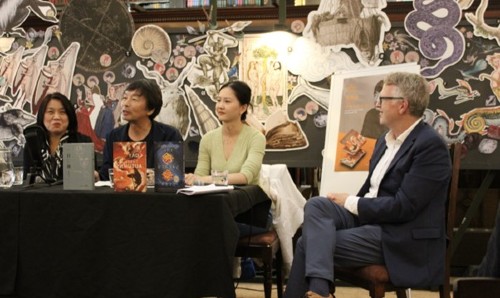 Four people sat at a table at a book release event